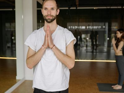 A focused expression of a person during a challenging yoga posture.