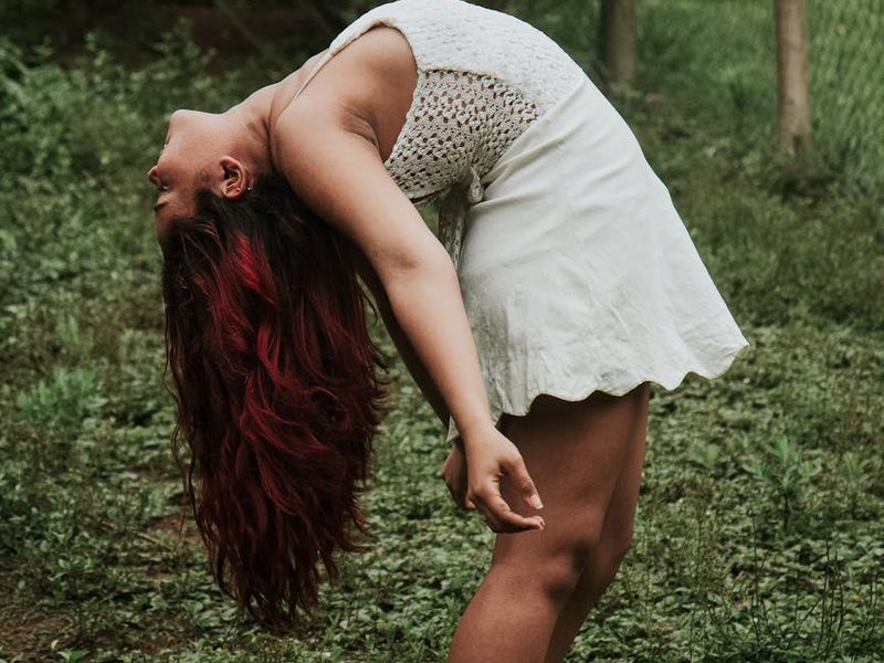 Person in a dynamic yoga flow pose, showing movement and grace.